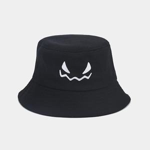 Detail shot of Halloween bucket hat with white ghost face embroidery on black cotton fabric