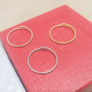 Three twisted titanium steel rings in gold, silver, and rose gold with adjustable open bands