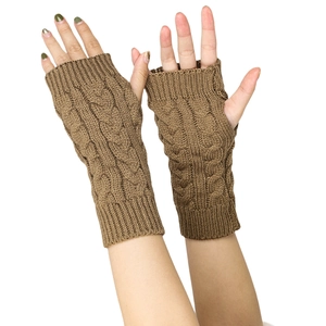 Close-up of brown cable knit fingerless gloves showing detailed texture and wrist coverage