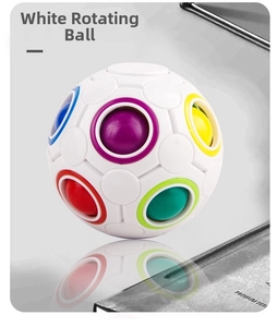 Close-up of white puzzle rainbow ball featuring 12 colorful sliding holes on a reflective surface