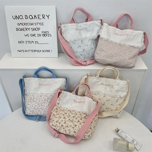 Close-up of assorted floral canvas bags with lace trim and adjustable shoulder straps