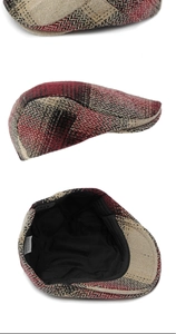 Detail of red and black herringbone newsboy cap with inner lining and washing label