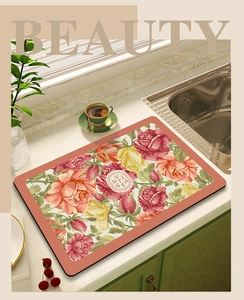 Detail of absorbent kitchen drying mat with vintage red and yellow rose floral patterns