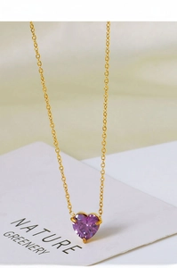 Detail of a purple heart zircon pendant with a delicate 18k gold plated chain