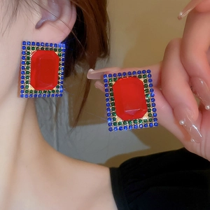 Vintage square stud earrings with red crystal and blue-green rhinestones on ear