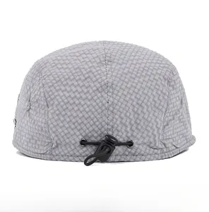 Adjustable buckle detail on the back of a grey checkered summer beret cap