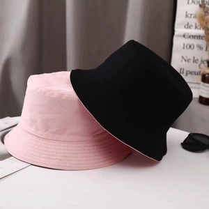 Reversible canvas bucket hat in pink and black for sun protection and casual wear