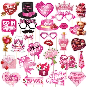 Set of 25 Valentine's Day party photo booth props with glittery hearts and love themes