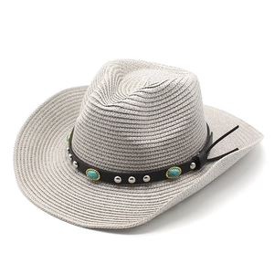 Detailed close-up of woven straw cowboy hat with turquoise stone leather band