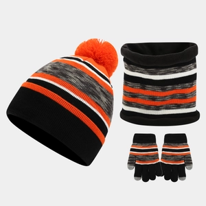 Detail of winter knit set featuring striped beanie with pom pom and touchscreen gloves
