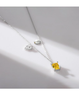 Detail of S925 silver double necklace with yellow square gem and Leo zodiac pendant