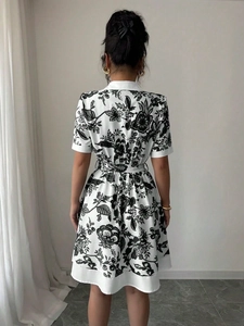 Back view of a short-sleeved printed dress with a waist tie and floral patterns