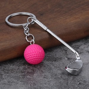 Creative silver golf club keychain with a mini pink ball on a stylish rustic background