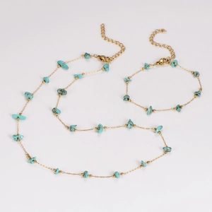 Detail of delicate gold chain necklace and bracelet with turquoise gravel accents