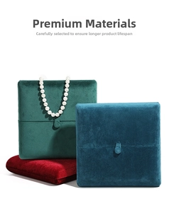 Velvet jewelry boxes in emerald, blue, and red with snap closure and soft texture