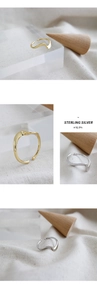 Macro shot of minimalist wave S925 sterling silver rings in gold and silver finishes