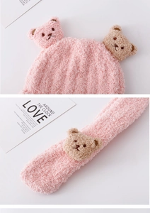 Detail view of pink teddy fleece scarf with cute 3D bear plush figures and soft texture