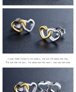 Macro detail of S925 sterling silver stamp on interlocking dual-tone heart earrings