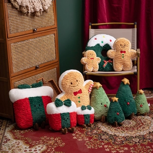 Plush Gingerbread Man, Christmas Tree, and Gift Box cushions in a festive home setting