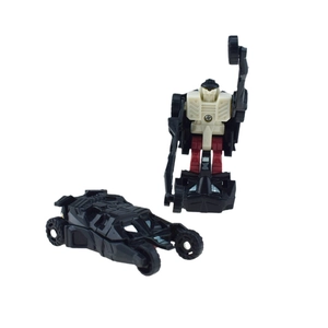 Macro detail of transformable black robot toy switching from battle car to warrior form