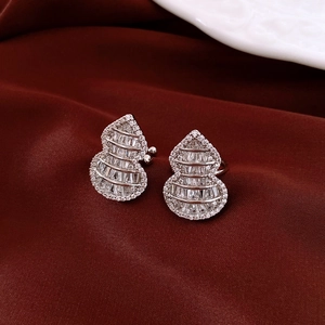 Elegant silver gourd stud earrings with pavé-set zircons on deep red silk background