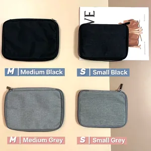 Portable organizer bag for Apple Watch straps and cables in grey and black finishes