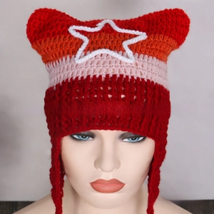 Detail view of handmade crochet cat ear hat with colorful stripes and white star patch