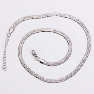 Detail of silver stainless steel flat snake chain with lobster clasp on white background