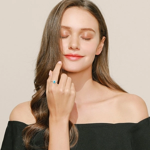 S925 sterling silver crown ring with oval turquoise stone worn on a model finger