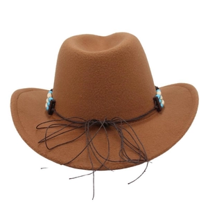Detail of western cowboy hat featuring ethnic turquoise beaded band and brown felt texture