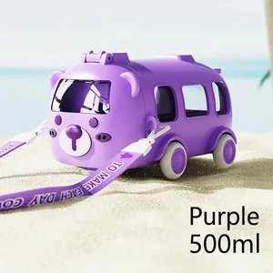 Detail of purple bear-shaped bus water bottle with adjustable strap on beach sand