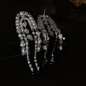 Macro shot of silver drop earrings with long chain tassels and shimmering rhinestones