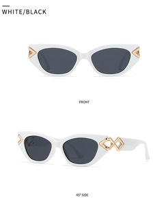 Detail view of white cat-eye sunglasses featuring golden geometric hollow metal ornaments