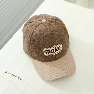 Detail of winter baseball cap featuring brown fleece material and beige corduroy brim