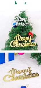 Detail of glittery gold and silver Merry Christmas letter ornaments for tree decoration