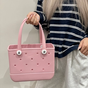 Detailed side view of pink EVA beach bag with signature perforated holes and sturdy handles