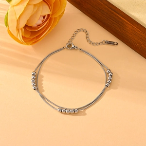 Detailed macro view of double-layer stainless steel snake chain with metallic beads
