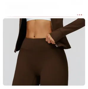 Detail of high-waisted coffee sports pants featuring tummy control and sculpting fit