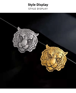 Detailed relief of metallic tiger head brooches in gold and silver finishes