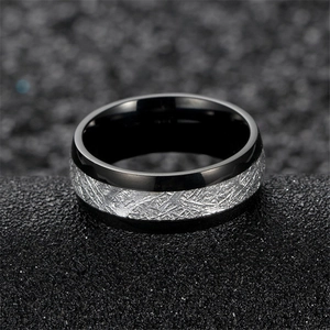 Macro shot of men's black stainless steel ring with silver meteorite pattern inlay