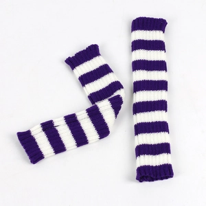 Close-up of knit fingerless gloves with purple and white stripes for winter warmth