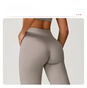 Detail shot of taupe high-waisted yoga pants featuring butt-lifting curved seams for sculpting