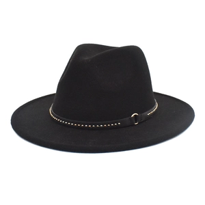Detail of wool fedora hat with gold studs and metal ring decoration on black band