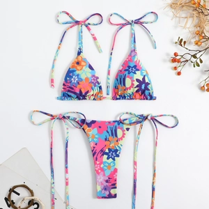 Flat lay of a two-piece bikini with colorful floral print and adjustable side ties