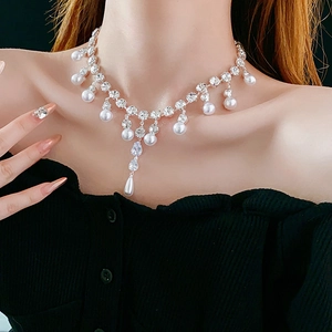 Close-up of elegant silver water-drop zircon and pearl fringe pendant necklace on model