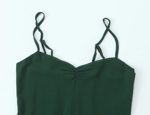 Detail of adjustable thin straps and pleated neckline on dark green camisole top