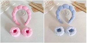 Detail view of pink and light blue plush sponge headbands with matching wristbands