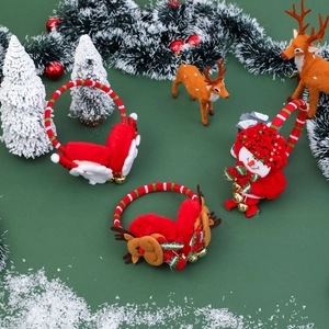Plush Christmas earmuffs with Santa, reindeer and snowman designs on green background