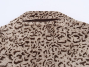 Detailed view of leopard print faux fur texture and stitching on the coat's back collar