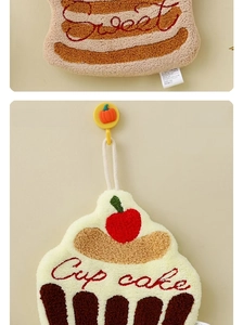 Detail of hanging cupcake coral fleece hand towel with heart embroidery and sweet design